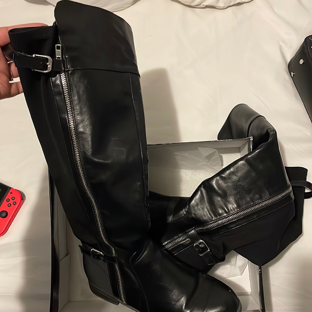 Black faux leather boots.